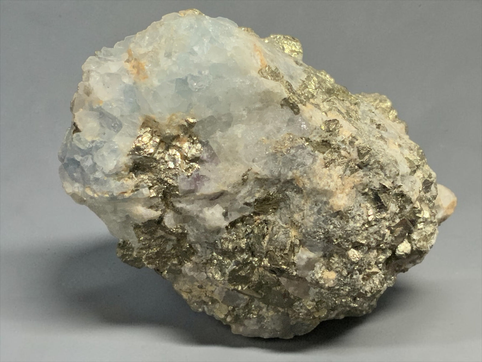 Pale blue fluorite with bright metallic pyrite from the Climax Mine