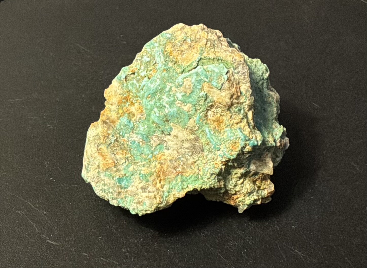 Blue-green Leadville turquoise in natural matrix on a black background